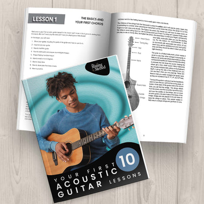 Your First 10 Acoustic Guitar Lessons from The Missing Method for Guitar. Image of two copies of the book on a table, one open to display the first pages of the first lesson, and the second closed, displaying the front cover.