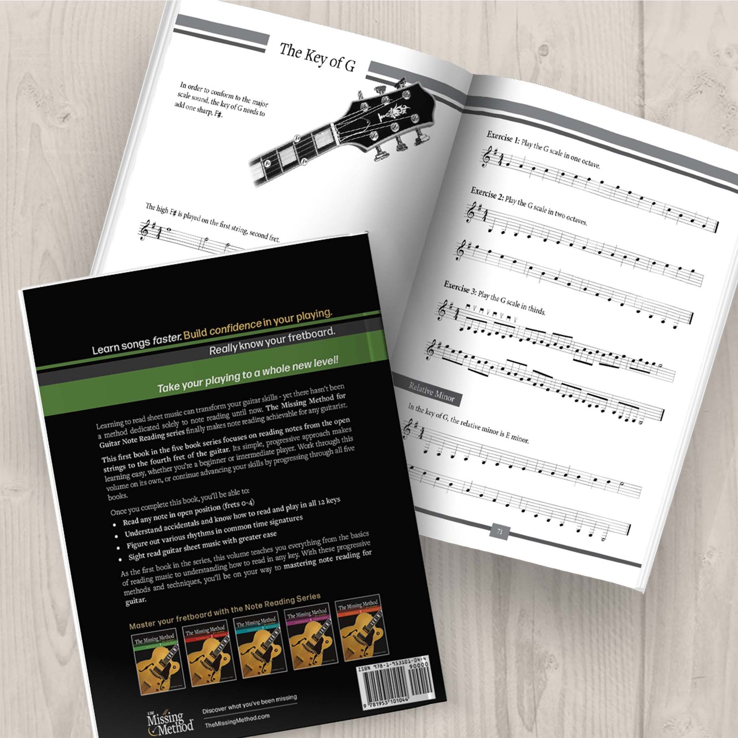 The Missing Method for Guitar Note Reading Book 1 Paperback on table displaying the back cover and another copy open, displaying pages 70-71