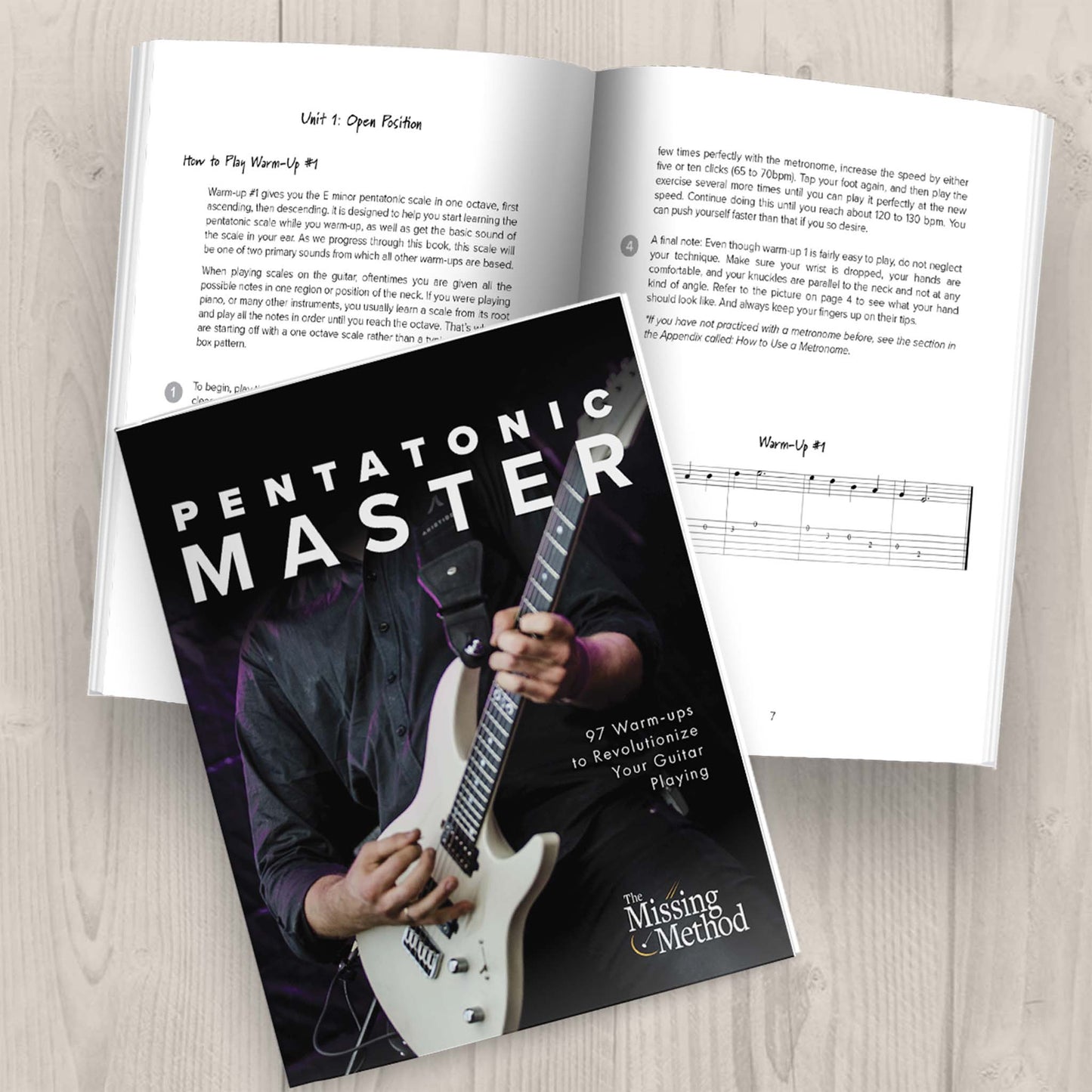 Pentatonic Master from The Missing Method for Guitar. Two copies of the book are displayed on a table. One copy is open, displaying the first pages of the first unit. The other copy of the book is closed, displaying the front cover.
