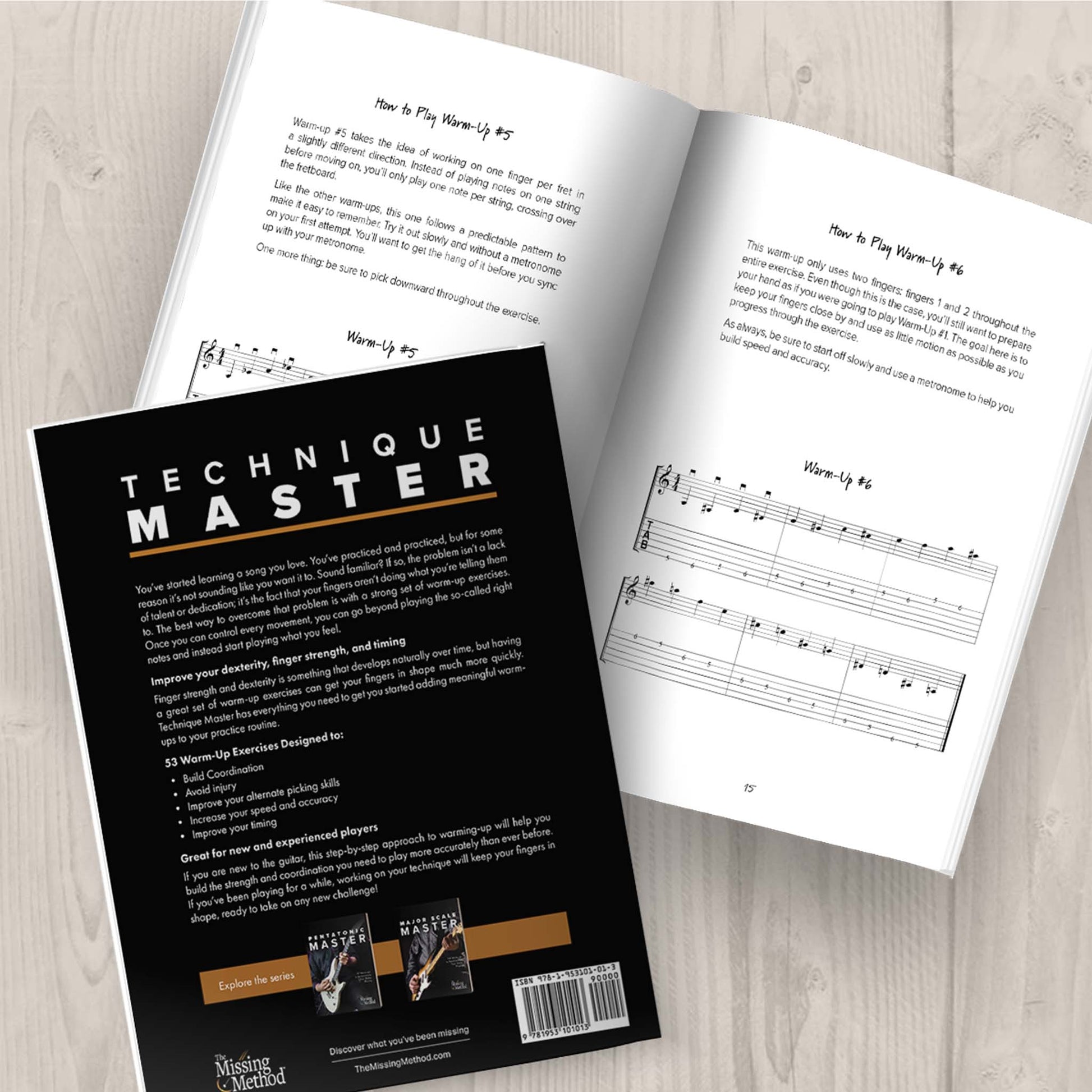 Technique Master from The Missing Method for Guitar. Image of two copies of the book on a tabletop, one open and displaying some of the first set of warm-ups. The second book closed, displaying the back cover.