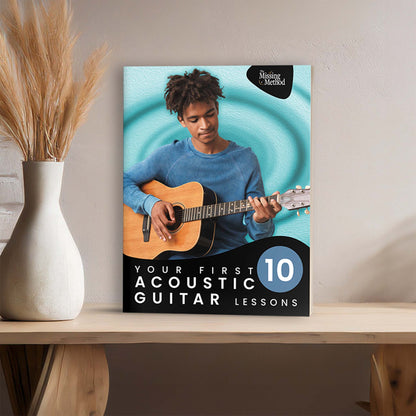 Your First 10 Acoustic Guitar Lessons from The Missing Method for Guitar. Image of book displayed on a table beside home decor.
