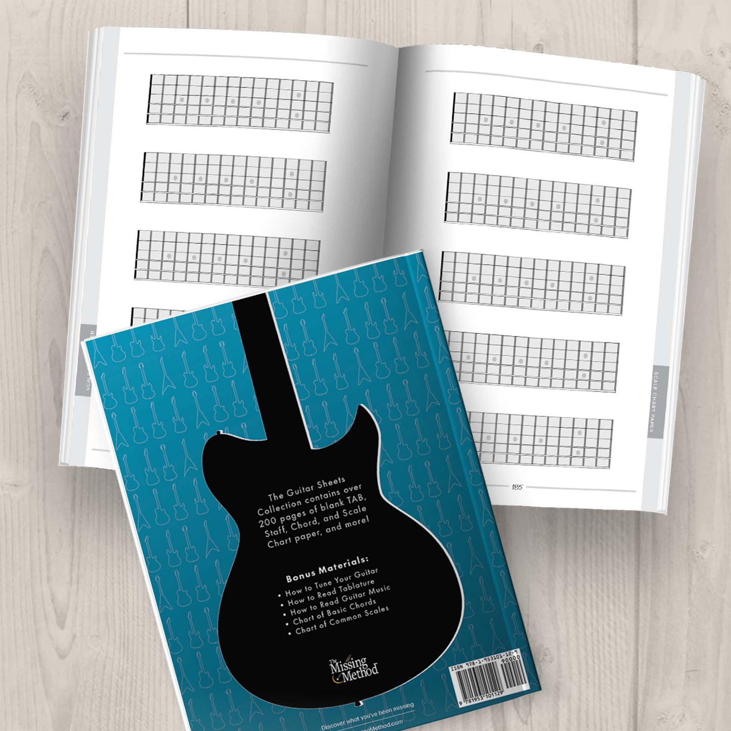 Guitar Sheets Collection Book from The Missing Method for Guitar. Back cover displayed plus open book displaying pages 184-185 of blank scale chart paper.