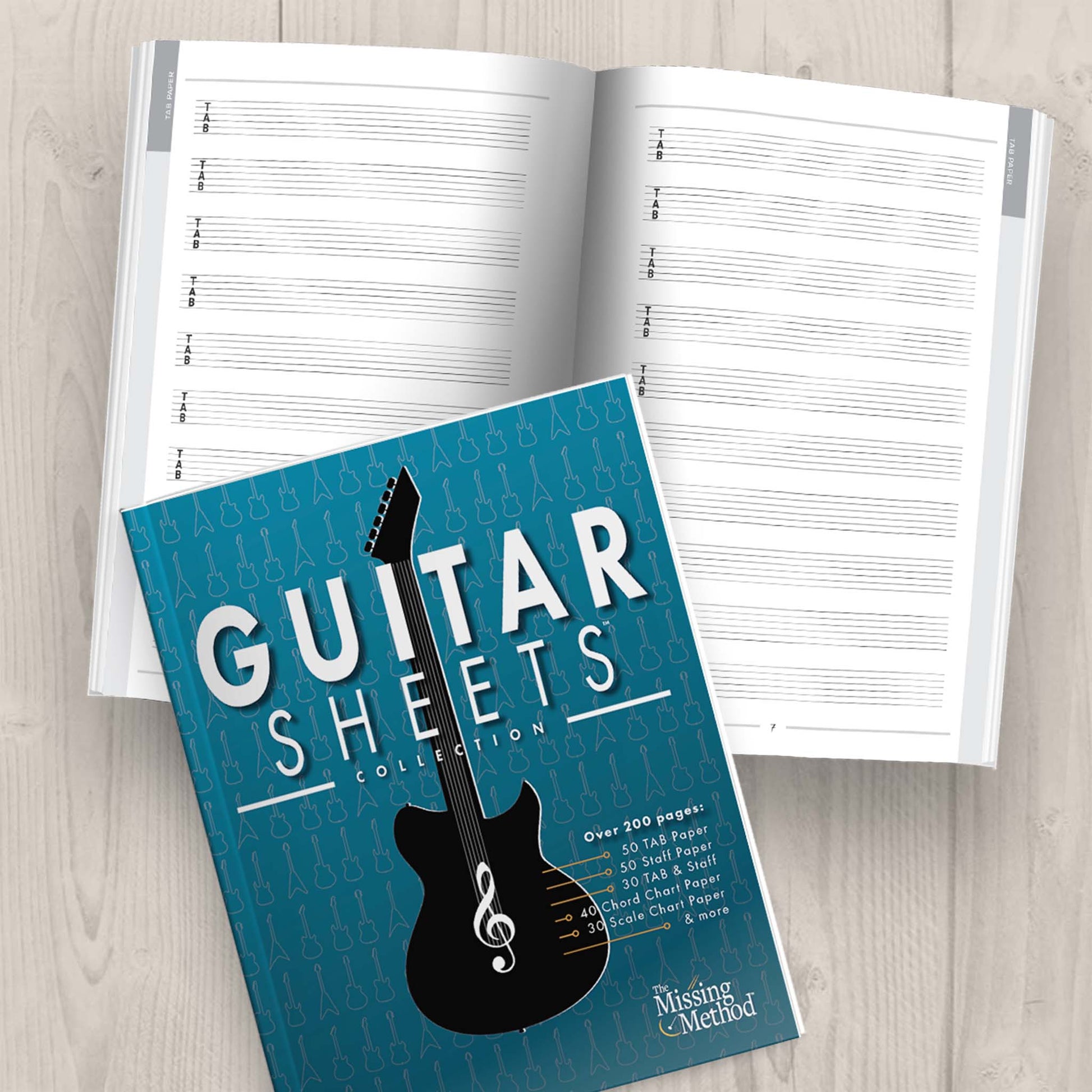 Guitar Sheets Collection Book from The Missing Method for Guitar. Front cover displayed plus open book displaying pages 6-7 of blank tablatuare paper.