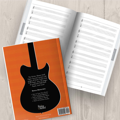 Guitar Sheets Staff Paper, Paperback book from The Missing Method for Guitar, displayed open on tabletop, showing both the back cover and interior pages. Copyright 2024 Tenterhook Books, LLC.