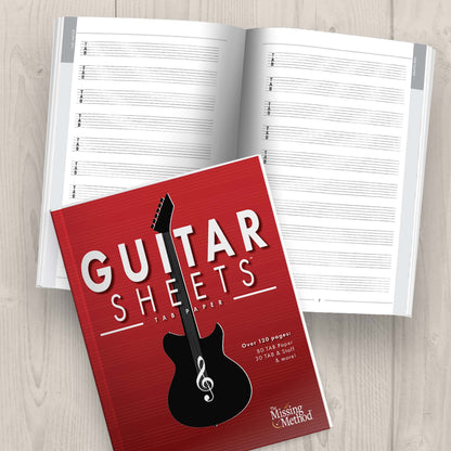 Guitar Sheets TAB Paper Journal from The Missing Method for Guitar, closed book displaying front cover and open book displaying pages on a tabletop
