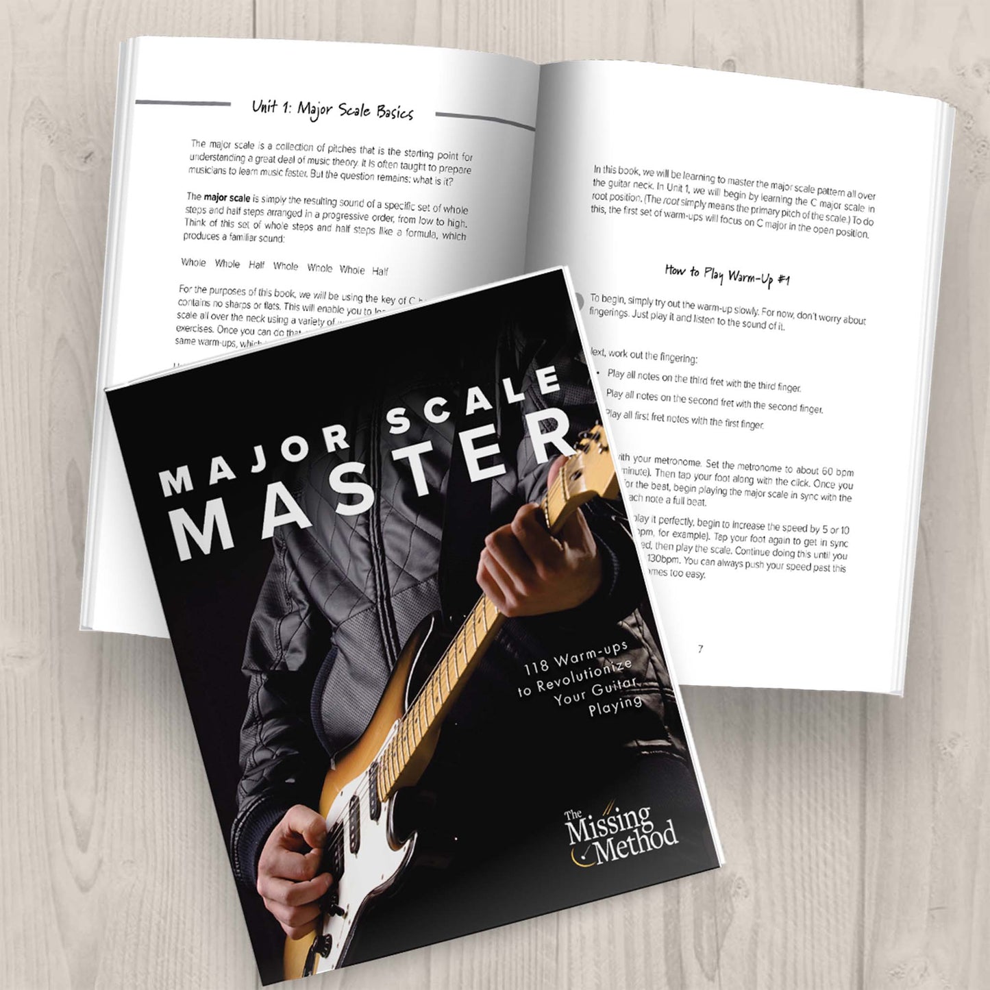 Major Scale Master from The Missing Method for Guitar. Image of two copies of the paperback book on a tabletop, one open displaying pages of the book, and the other closed, displaying the front cover.