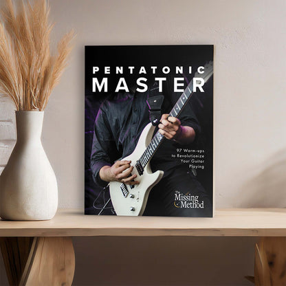 Pentatonic Master from The Missing Method for Guitar. Book displayed on a table with home decor, showcasing the front cover.