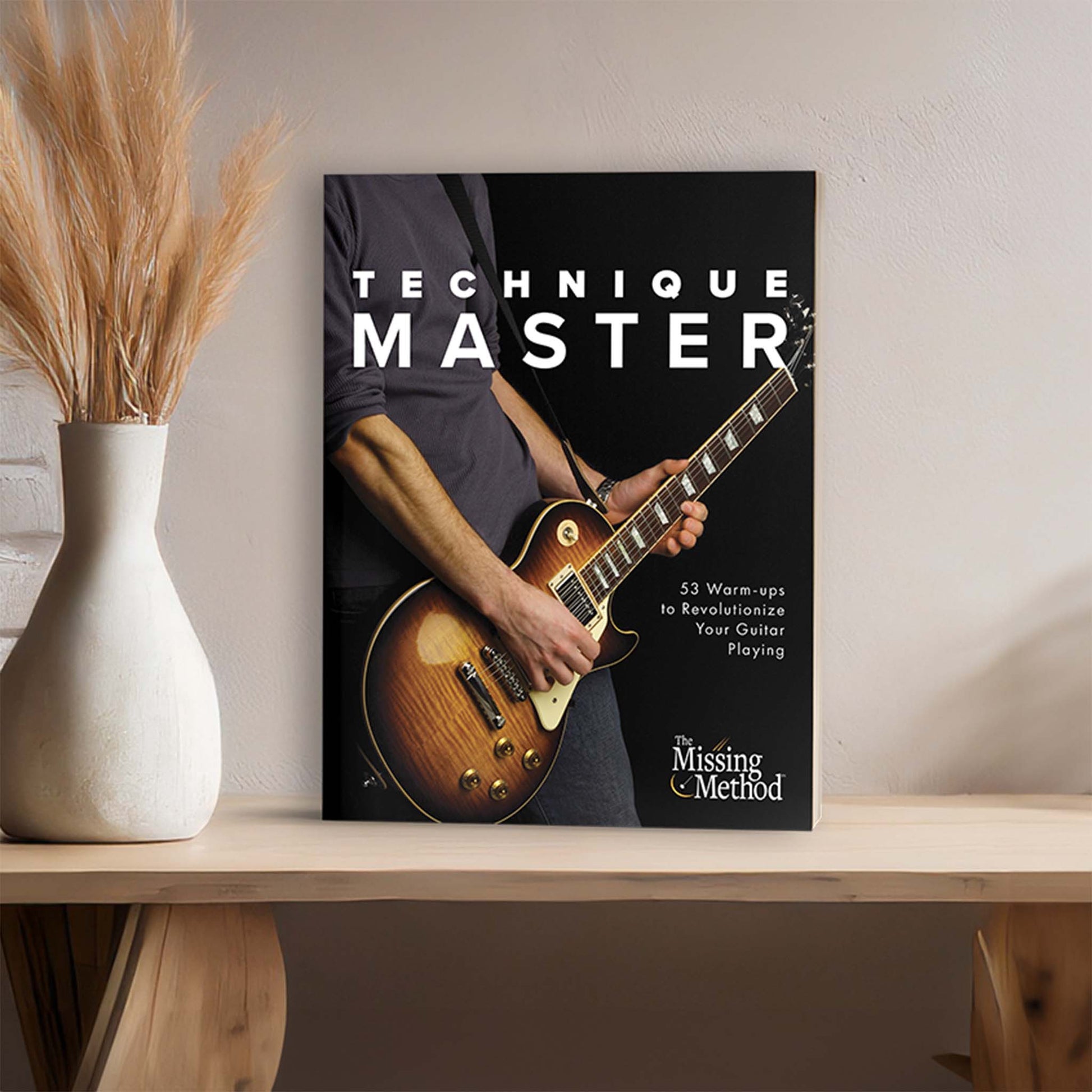 Technique Master from The Missing Method for Guitar. Image of book on shelf next to home to decor.